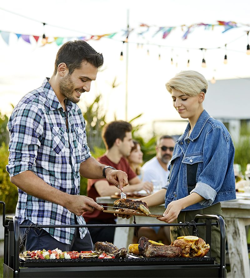 People having a BBQ in a backyard.