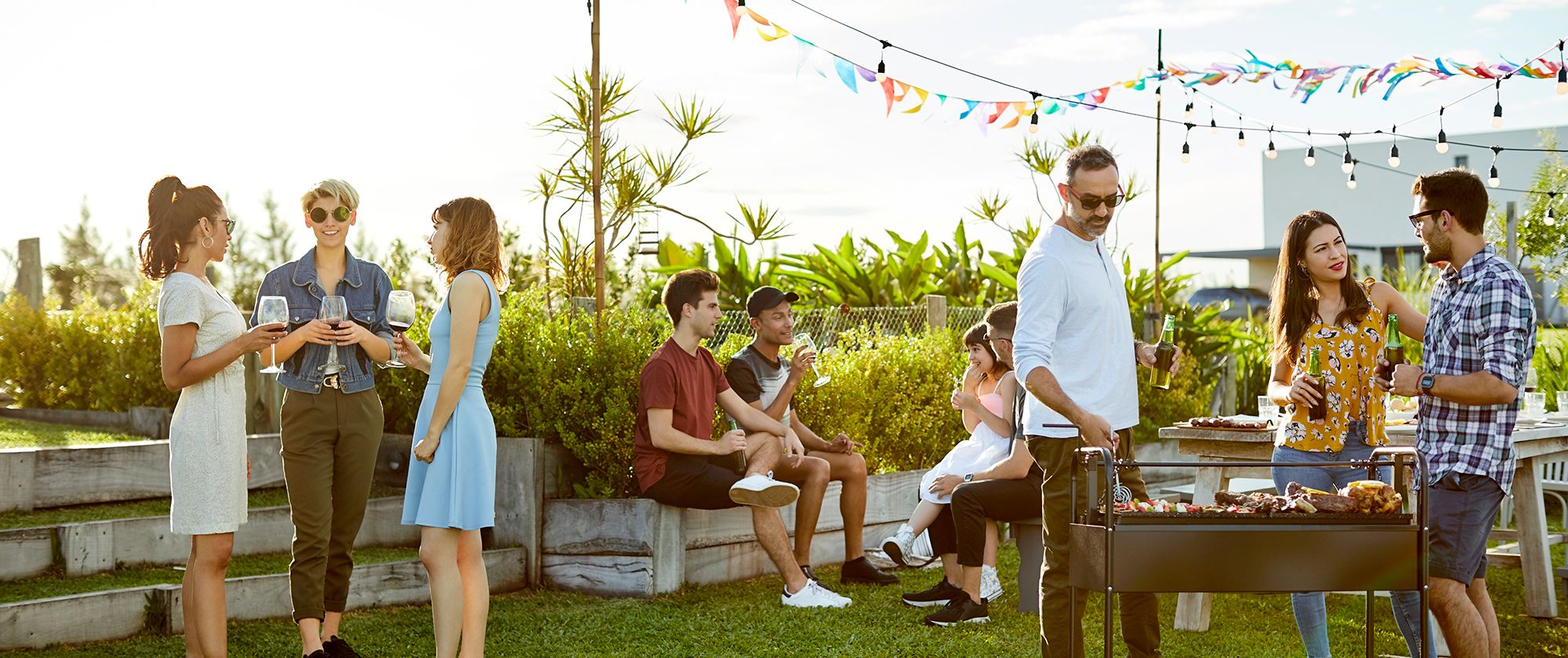 People having a BBQ in a backyard.