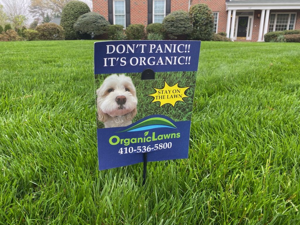 Organic Lawns sign in a front yard.
