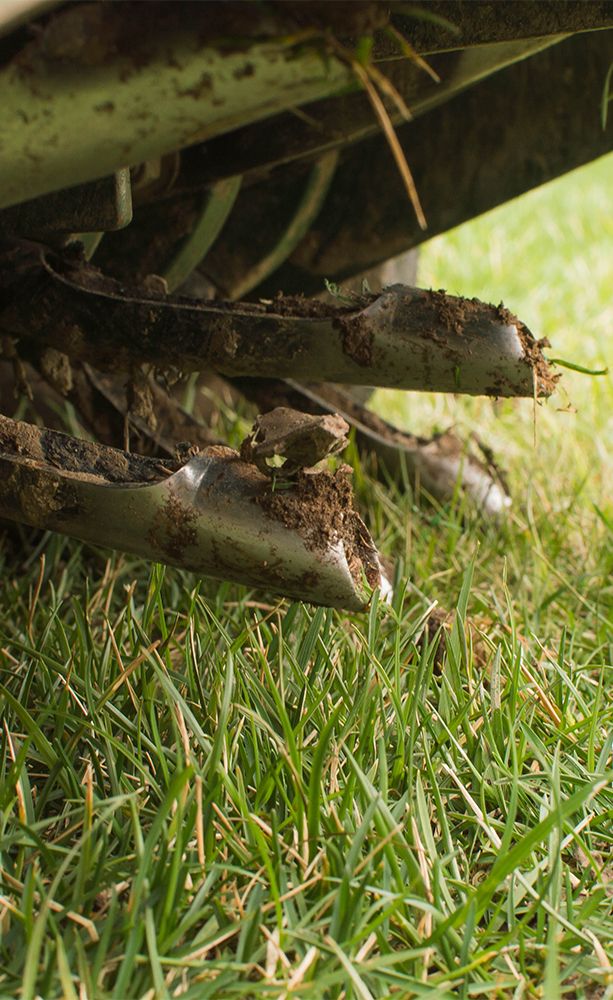 A lawn aerator pulling cores from yard.